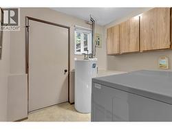 Laundry, Mechanical and Direct Access to Private and Fenced Backyard. -