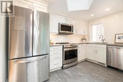 Cute kitchen tucked at the back of the main floor -