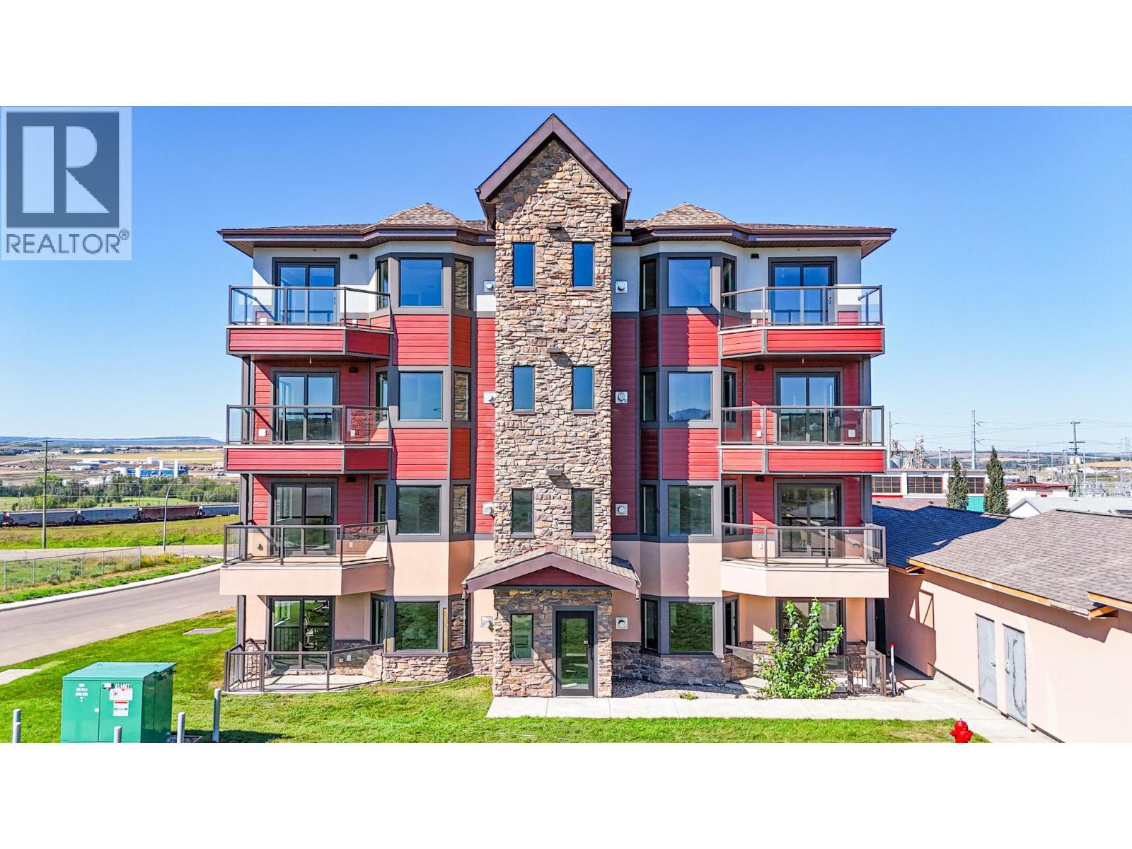 2032 86 Avenue Unit# 1401, Dawson Creek, BC - Outdoor With Balcony With Facade
