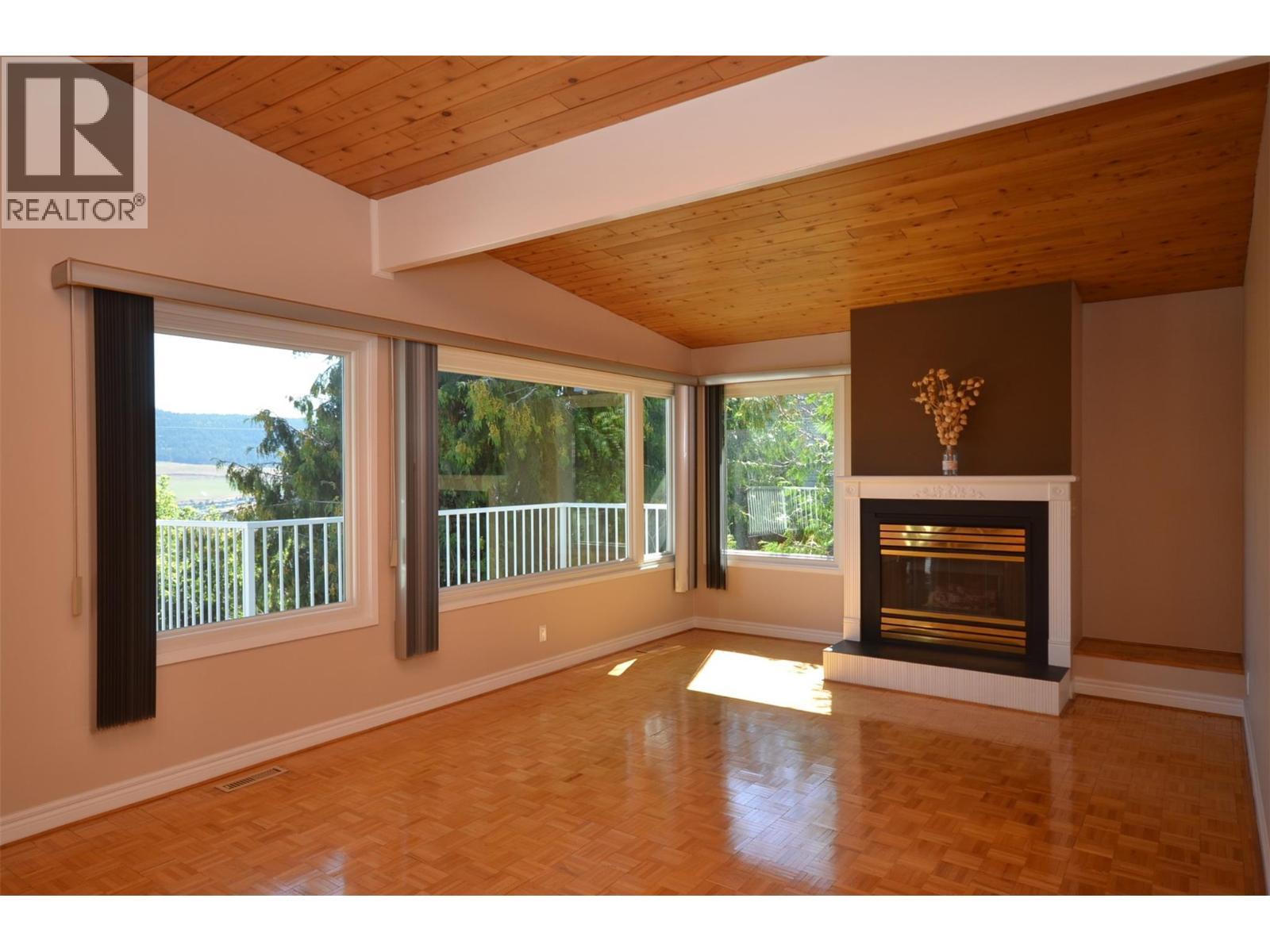 Vaulted ceilings - 6609 Southwind Road, Vernon, BC - Indoor Photo Showing Other Room With Fireplace