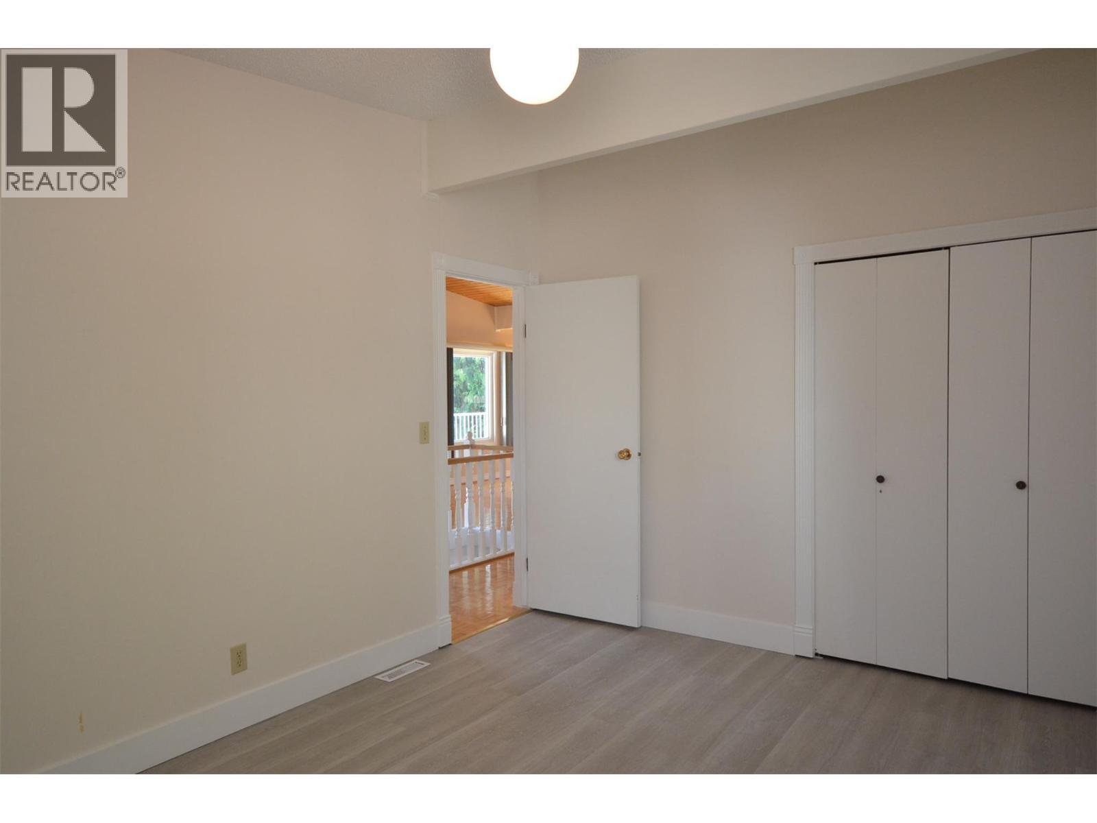 Second bedroom - double closets - 6609 Southwind Road, Vernon, BC - Indoor Photo Showing Other Room