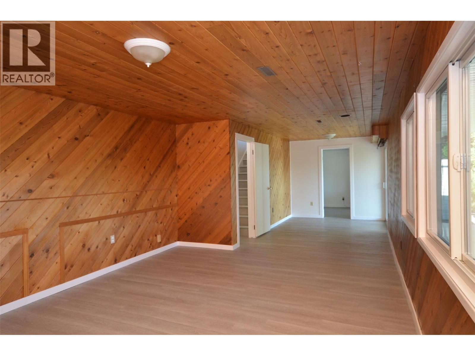 Very spacious, featured wood walls - 6609 Southwind Road, Vernon, BC - Indoor Photo Showing Other Room