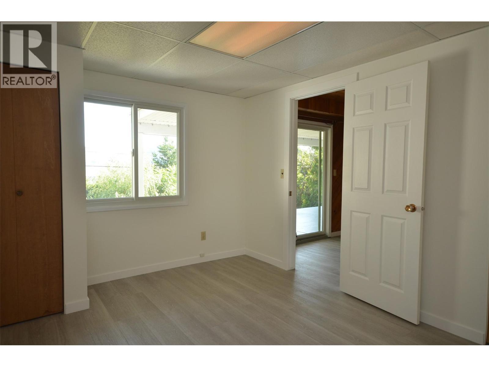 Fourth Bedroom overlooks backyard - 6609 Southwind Road, Vernon, BC - Indoor Photo Showing Other Room