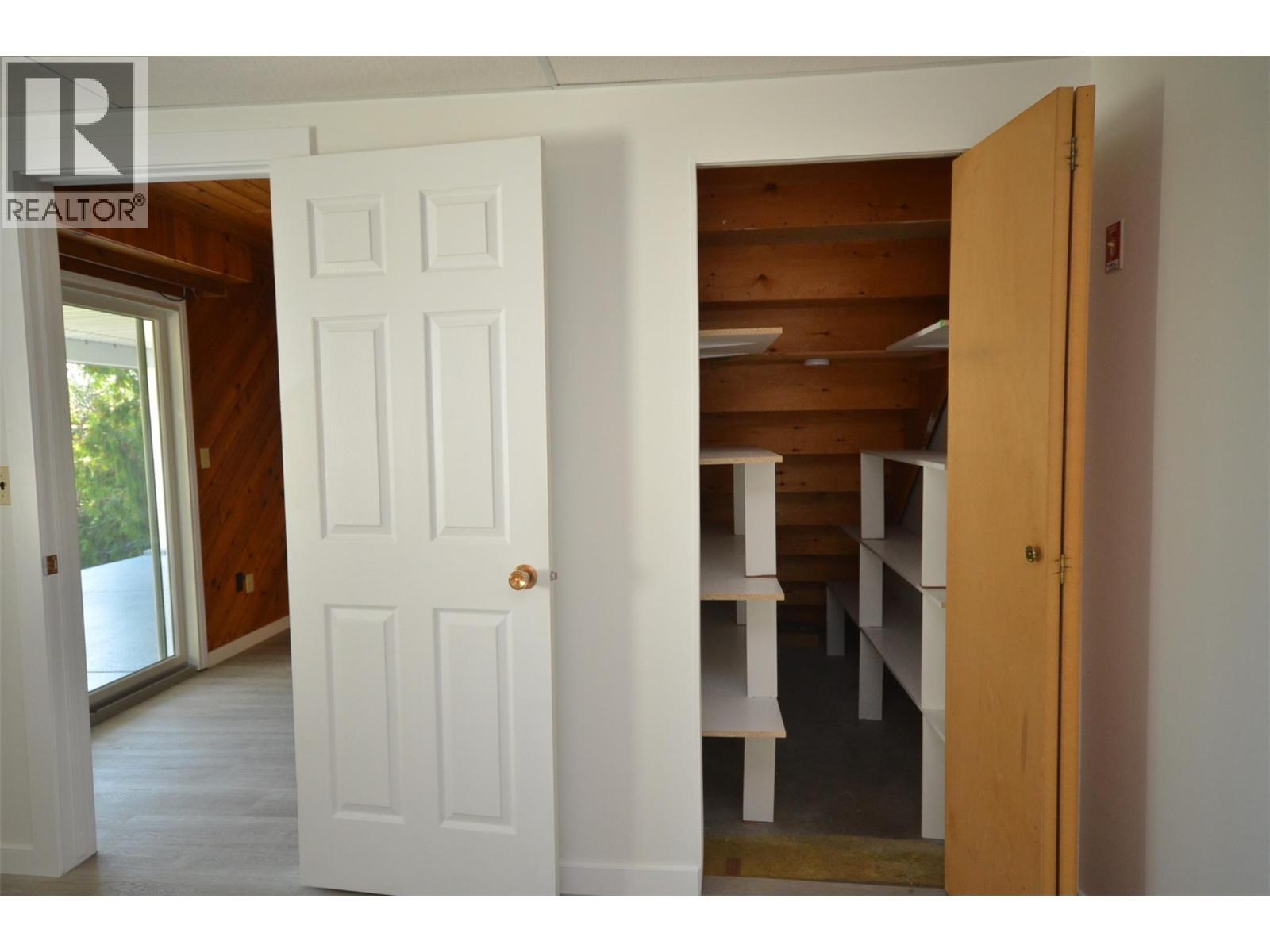 Walk in closet with shelves - 6609 Southwind Road, Vernon, BC - Indoor Photo Showing Other Room