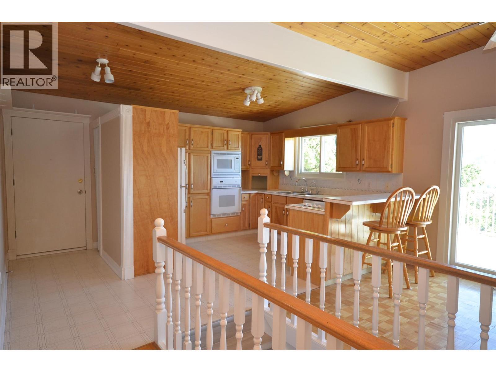 Kitchen and door to the garage on the left - 6609 Southwind Road, Vernon, BC - Indoor