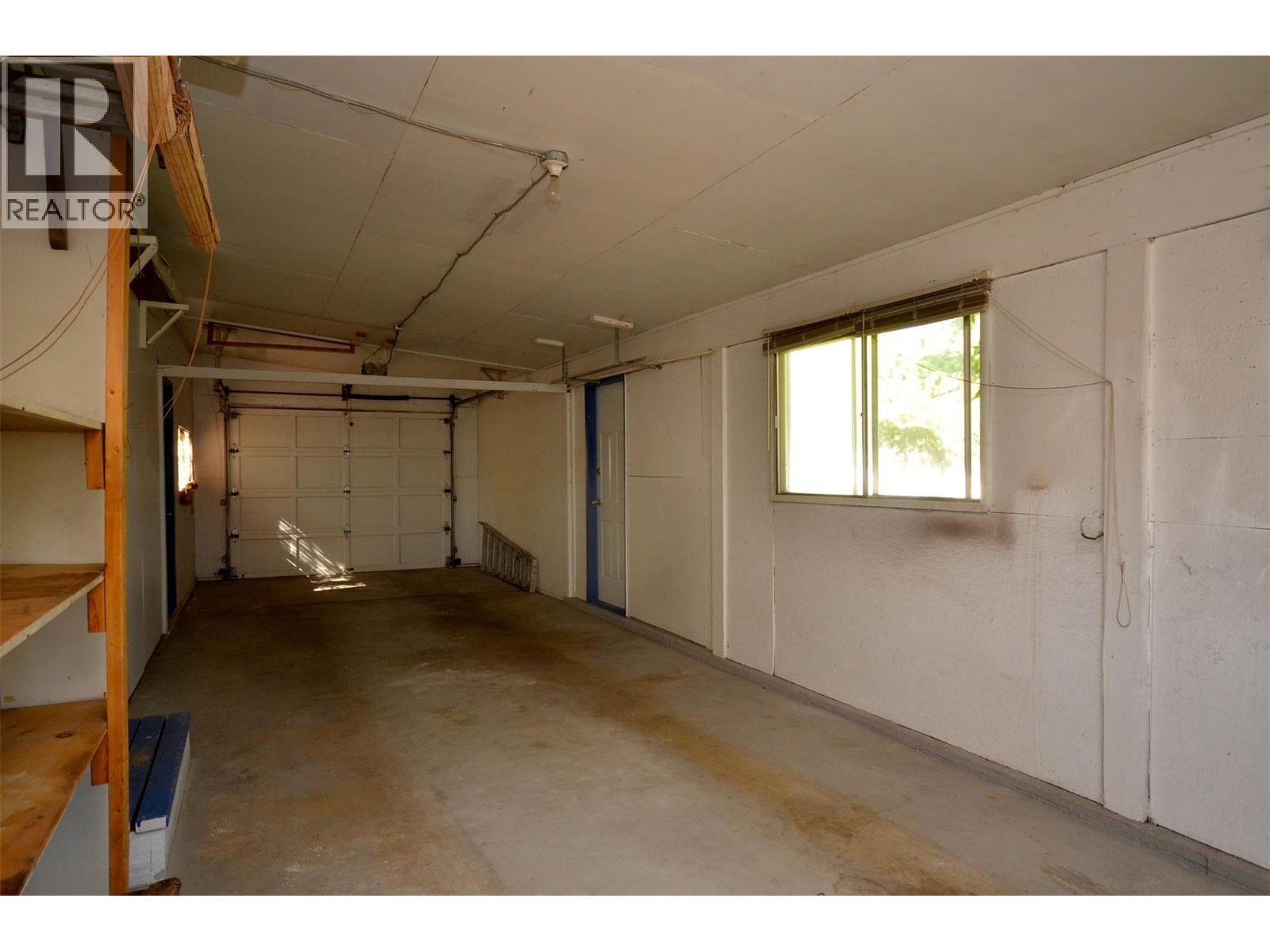 Double long single car garage - 6609 Southwind Road, Vernon, BC - Indoor Photo Showing Garage