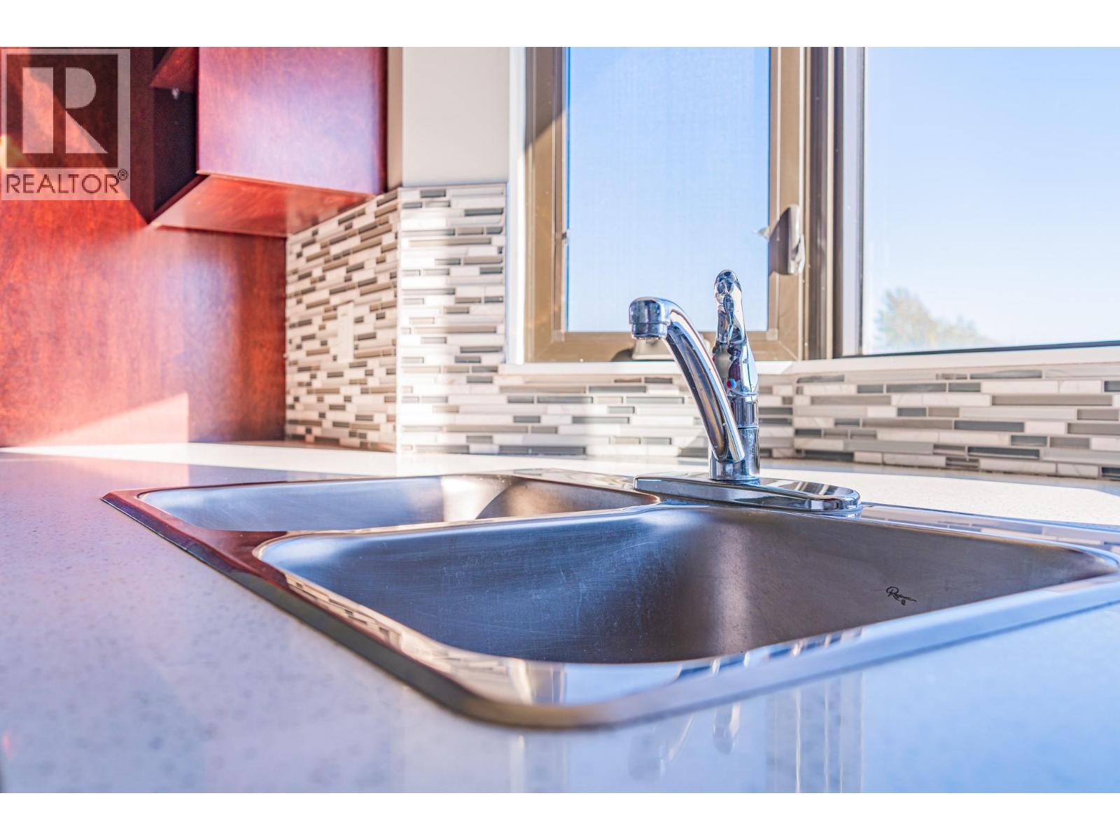 2032 86 Avenue Unit# 1201, Dawson Creek, BC - Indoor Photo Showing Kitchen With Double Sink