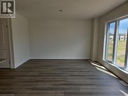 Spare room with dark wood finished floors and a textured ceiling -