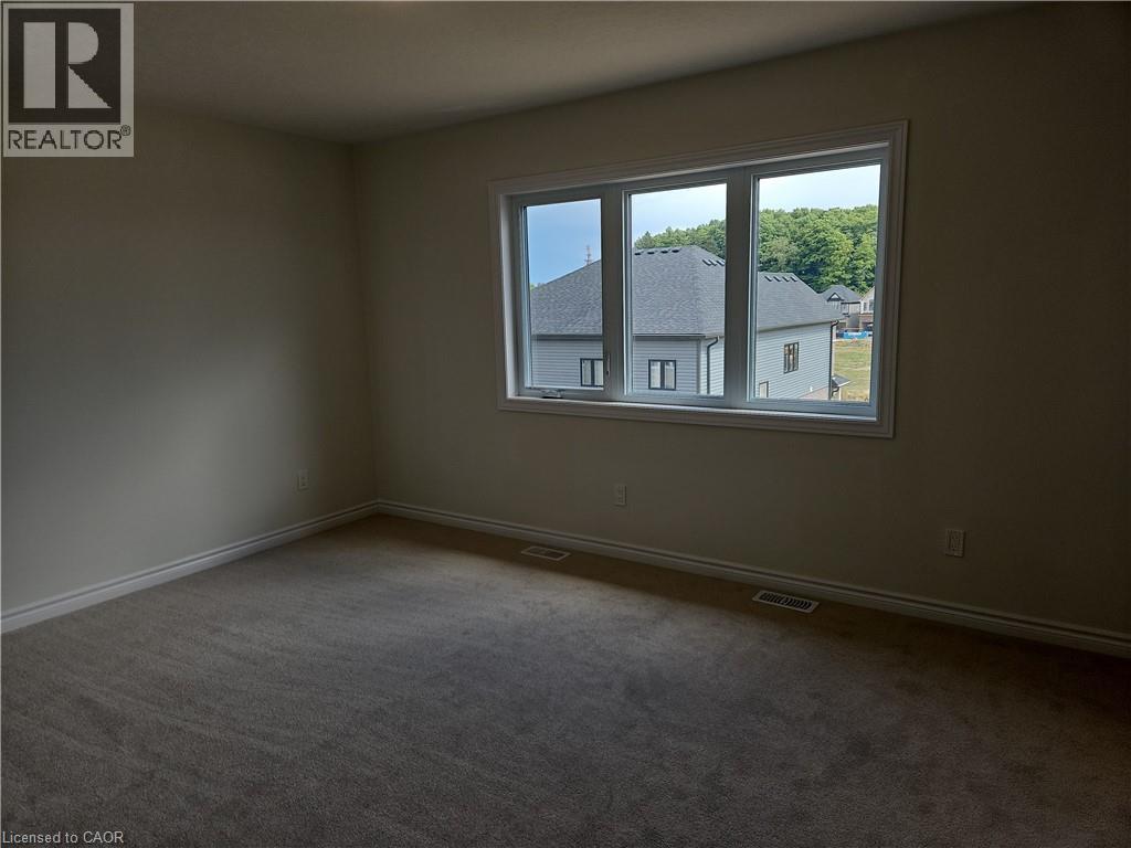 Spare room with carpet floors and baseboards - 261 Benninger Drive Unit# Upper, Kitchener, ON - Indoor Photo Showing Other Room
