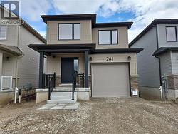 View of front of home featuring a porch, an attached garage, and dirt driveway -