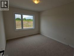 Spare room with carpet and baseboards -