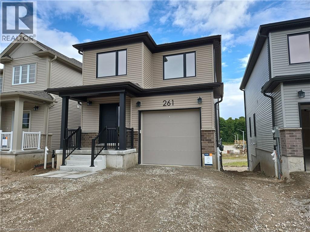 View of front facade featuring brick siding, a garage, and driveway - 261 Benninger Drive Unit# Upper, Kitchener, ON - Outdoor