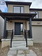 View of exterior entry with covered porch -