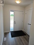 Foyer featuring baseboards and dark wood-type flooring -