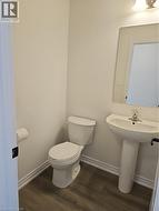 Half bathroom featuring baseboards and dark wood-style flooring -