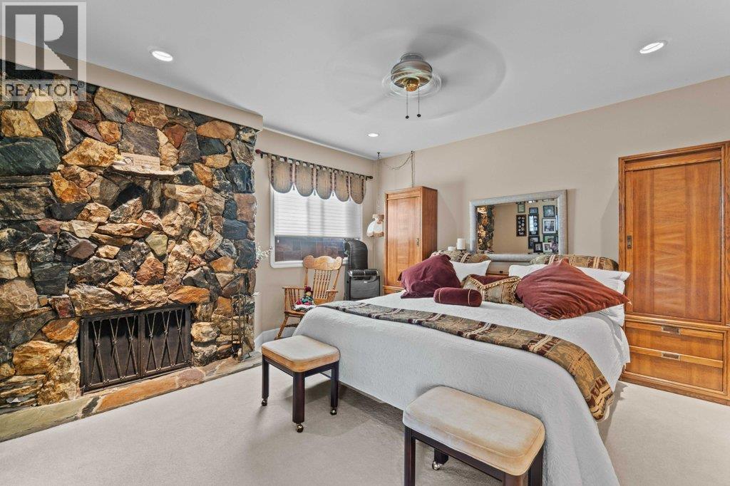 4842 Sunnybrae Canoe Point Road, Tappen, BC - Indoor Photo Showing Bedroom With Fireplace