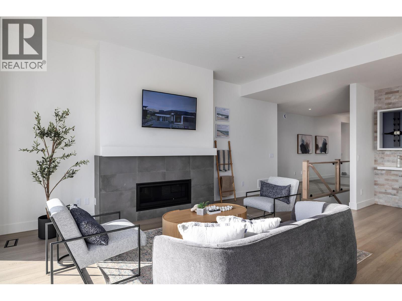 **Showhome photos - Actual home may differ in design, finishes, and features** - 4075 Sunstone Street, West Kelowna, BC - Indoor Photo Showing Living Room With Fireplace