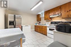 Eat-in kitchen with stove, hood fan, s/s fridge. -
