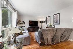 Corner natural gas fireplace in living room. -