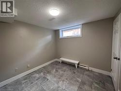 Empty room featuring a textured ceiling and baseboard heating -