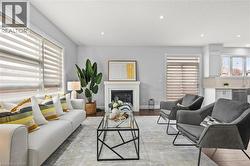 Living area featuring a glass covered fireplace, recessed lighting, and light wood finished floors -