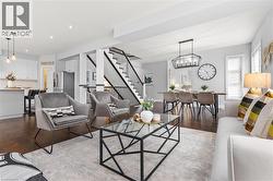 Living room featuring wood finished floors, stairs, a chandelier, and recessed lighting -