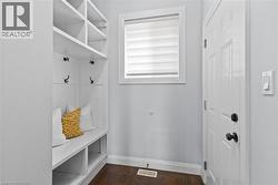 Mudroom featuring dark wood-style flooring and baseboards -