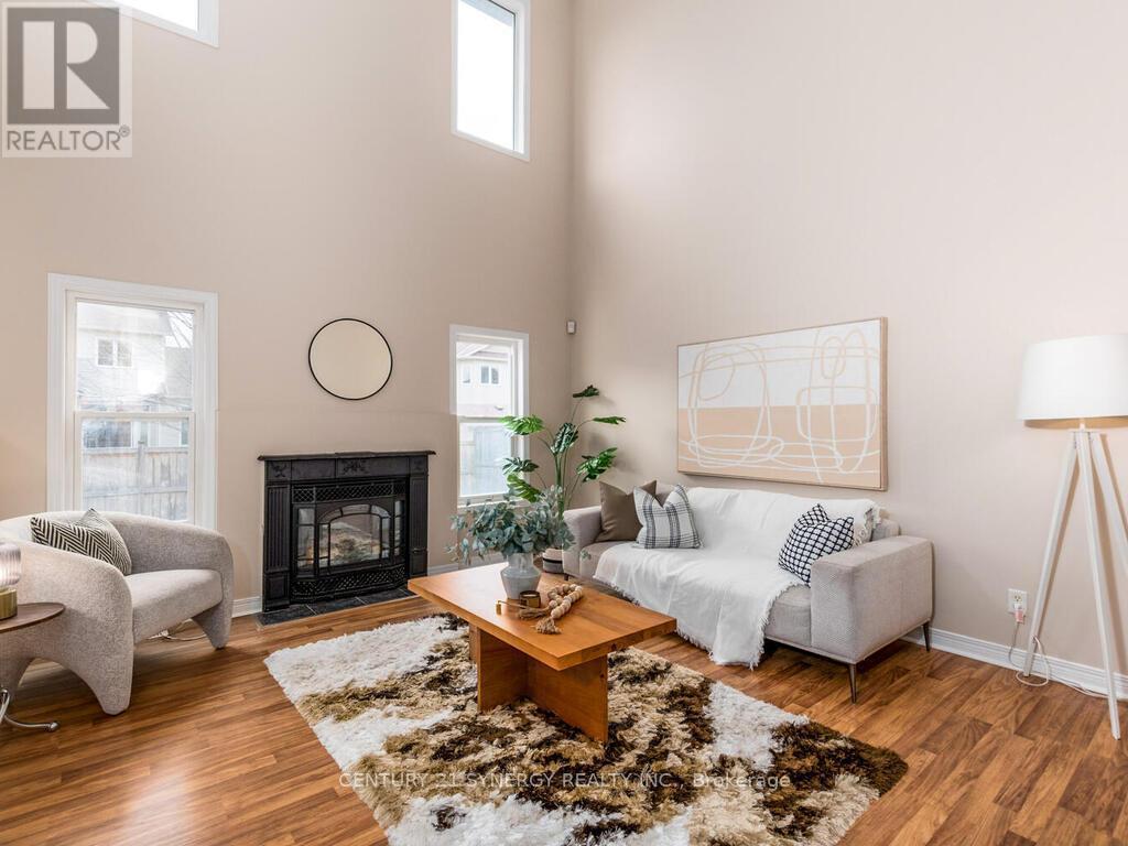 a Gas fireplace & lots of windows for brightness! - 34 Eliza Crescent, Ottawa, ON - Indoor Photo Showing Living Room With Fireplace
