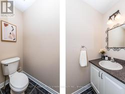 Powder room located by the stairs to the basement. -