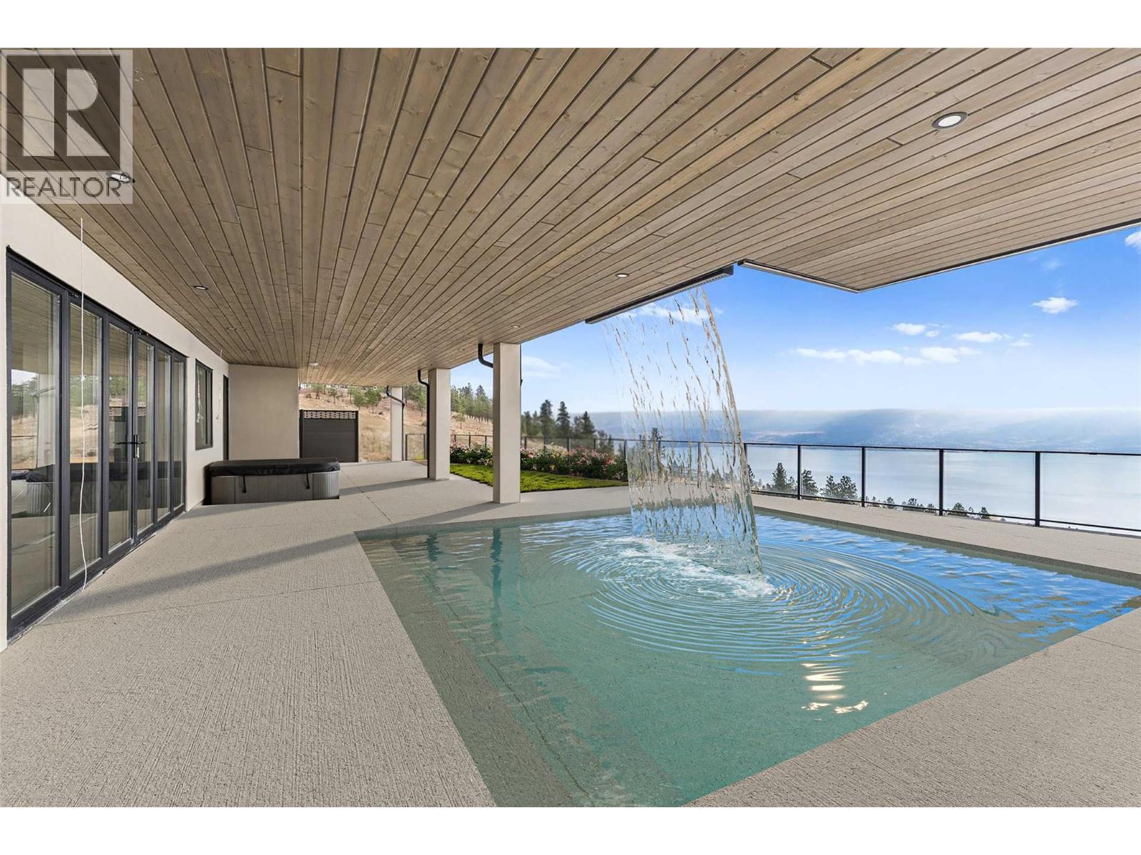 Recirculating overhead waterfall - 1359 Vineyard Drive, West Kelowna, BC - Outdoor With In Ground Pool