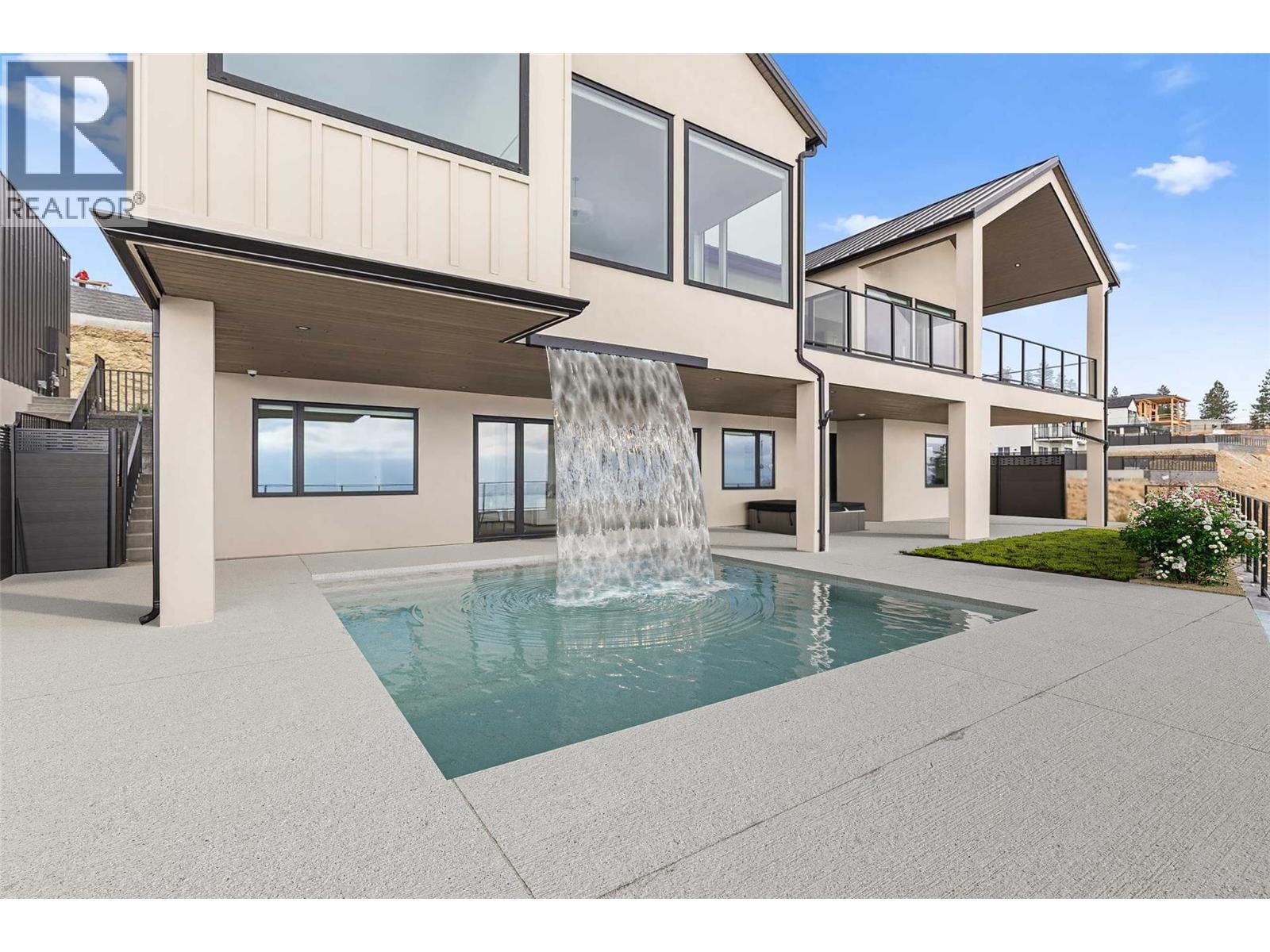 Custom pool with overhead waterfall - 1359 Vineyard Drive, West Kelowna, BC - Outdoor With In Ground Pool