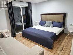 guest bedroom with patio doors onto the covered lower deck area, great for family play/reading room as well -