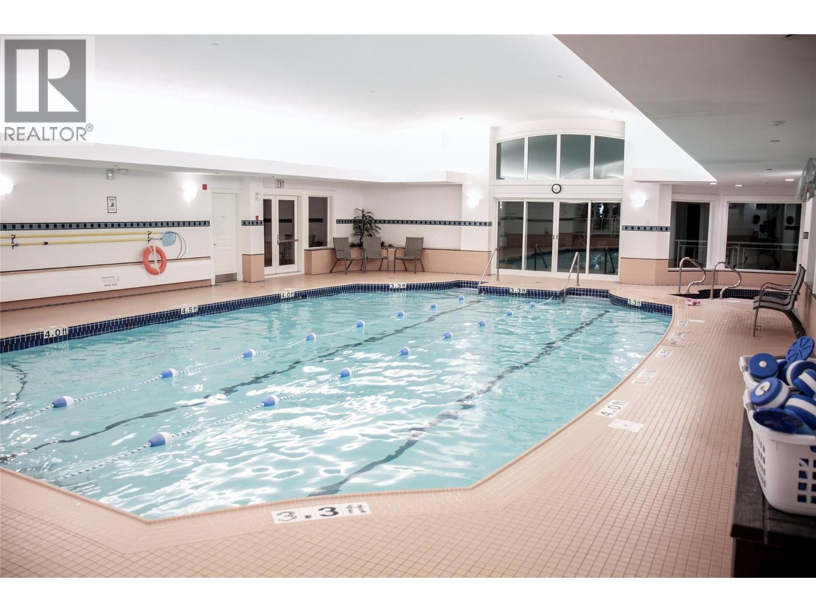 large indoor pool with hot tub and fitness equipment - 3897 Gallaghers Grange, Kelowna, BC - Indoor Photo Showing Other Room With In Ground Pool