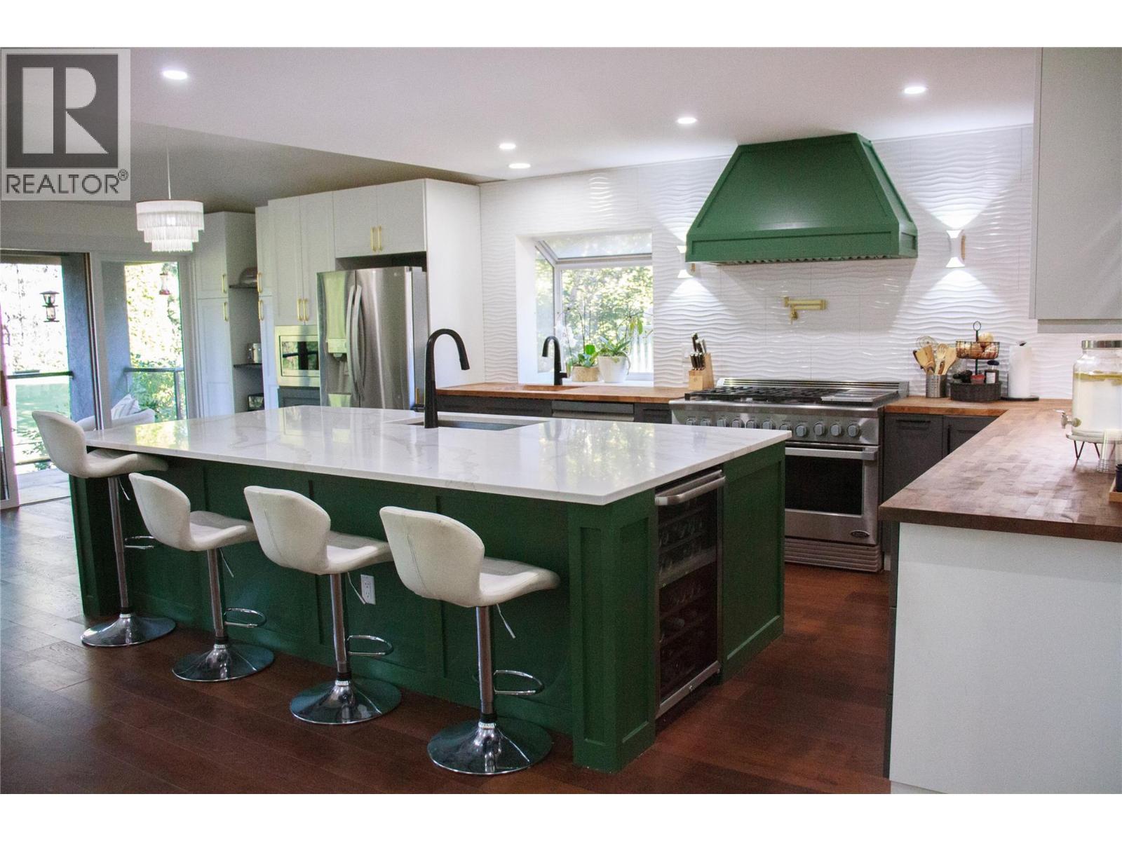 10ft x 5ft island with wine cooler and smart faucet - 3897 Gallaghers Grange, Kelowna, BC - Indoor Photo Showing Kitchen With Upgraded Kitchen