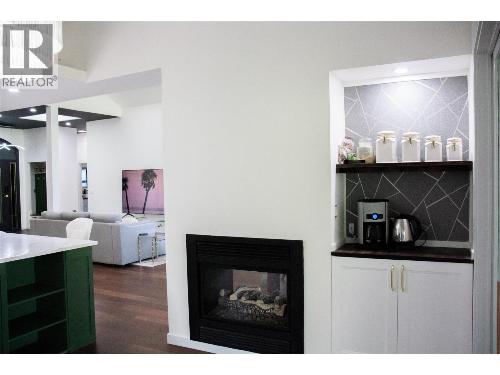 dedicated coffee bar with water line - 3897 Gallaghers Grange, Kelowna, BC - Indoor Photo Showing Other Room With Fireplace