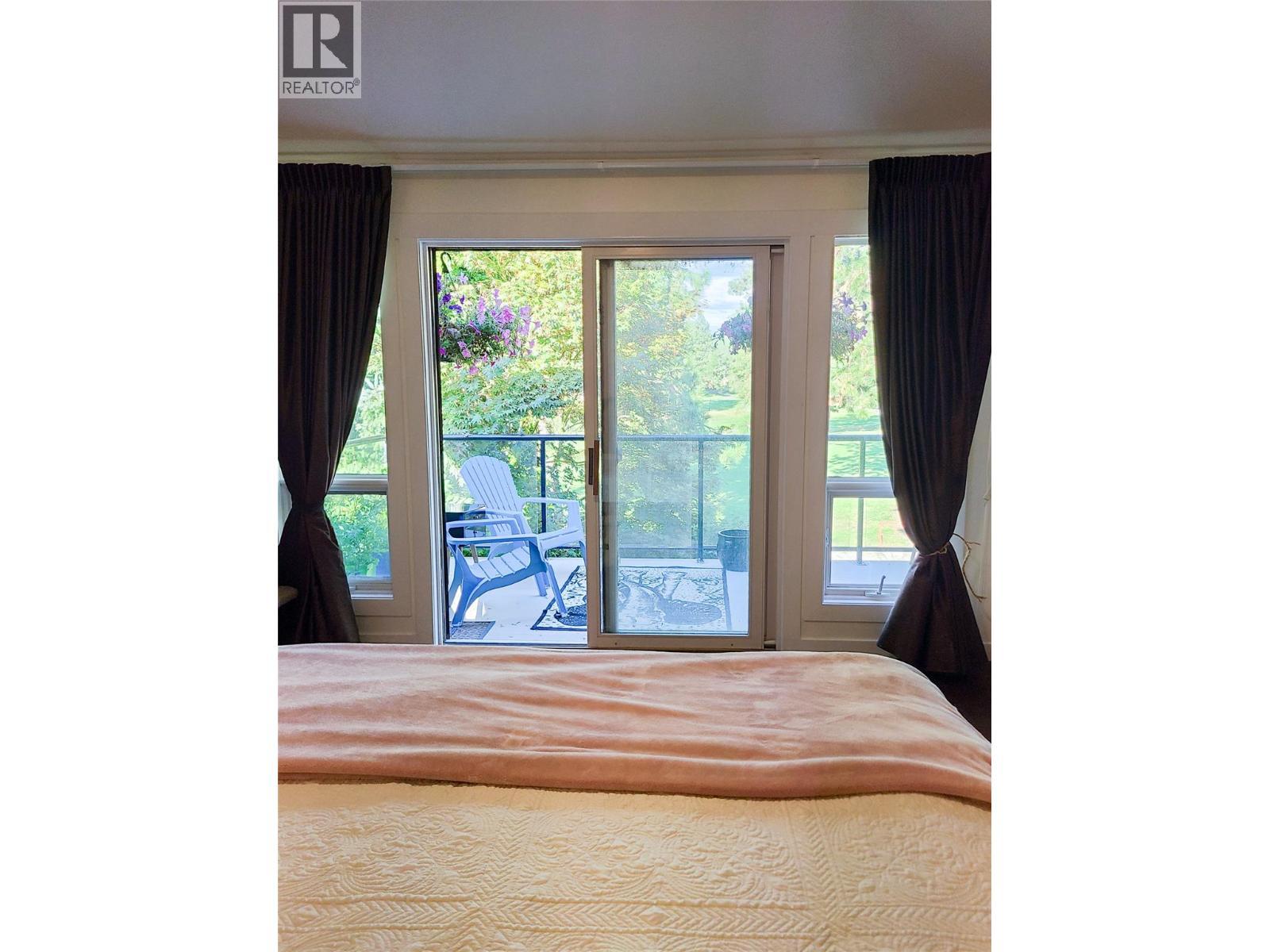 view of the course from master bedroom - 3897 Gallaghers Grange, Kelowna, BC - Indoor Photo Showing Bedroom