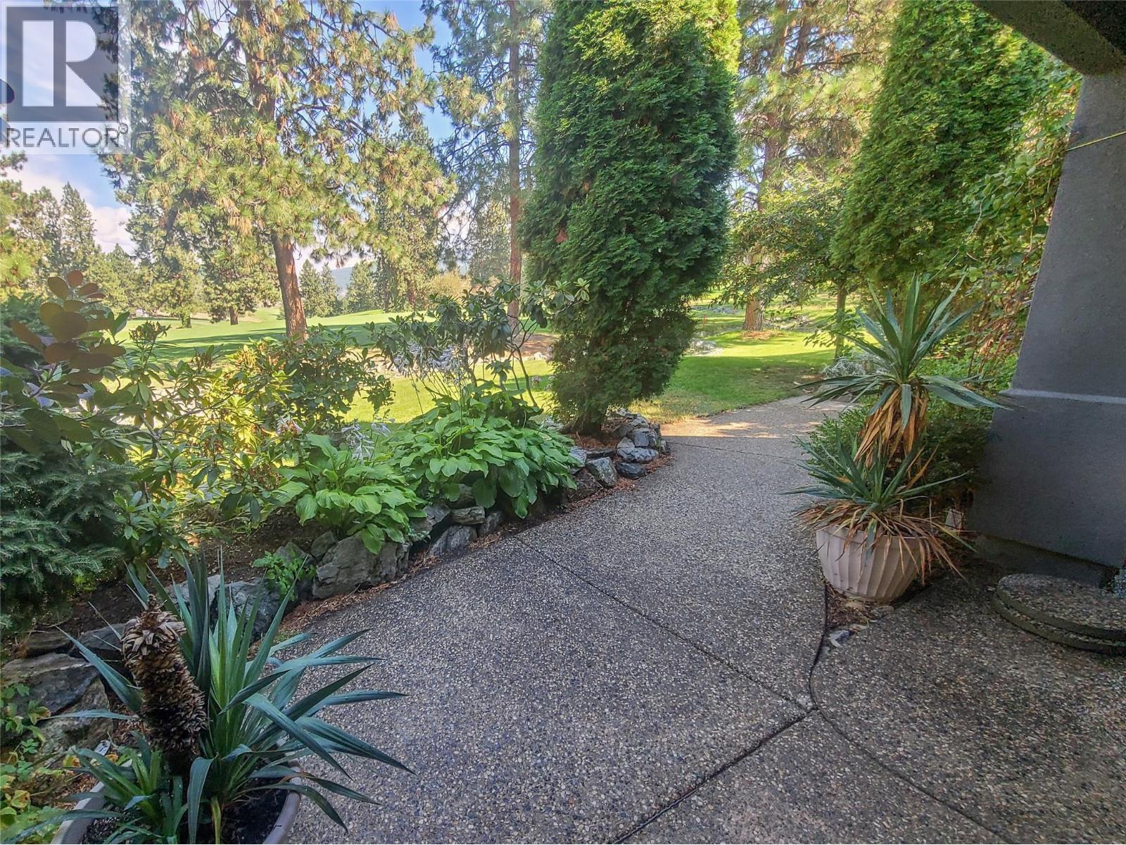 path leads onto the private pathway up to the clubhouse. fairway is across the small rock creek - 3897 Gallaghers Grange, Kelowna, BC - Outdoor