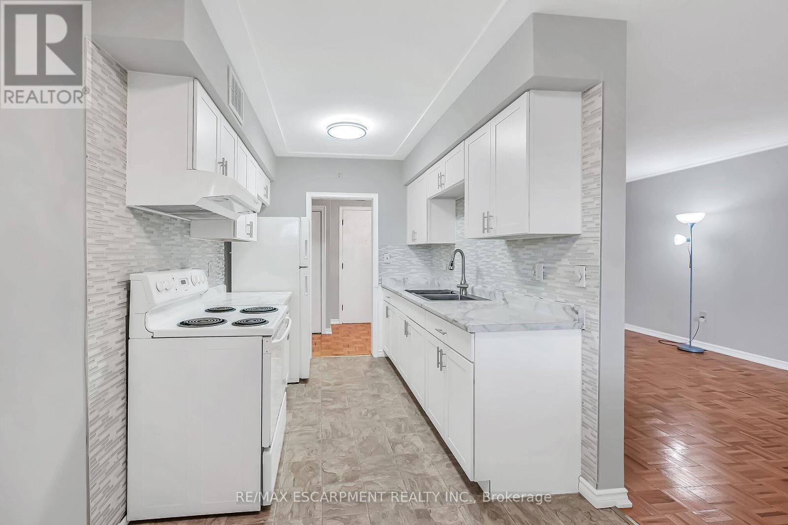 103 - 11 Woodman Drive S, Hamilton, ON - Indoor Photo Showing Kitchen With Double Sink