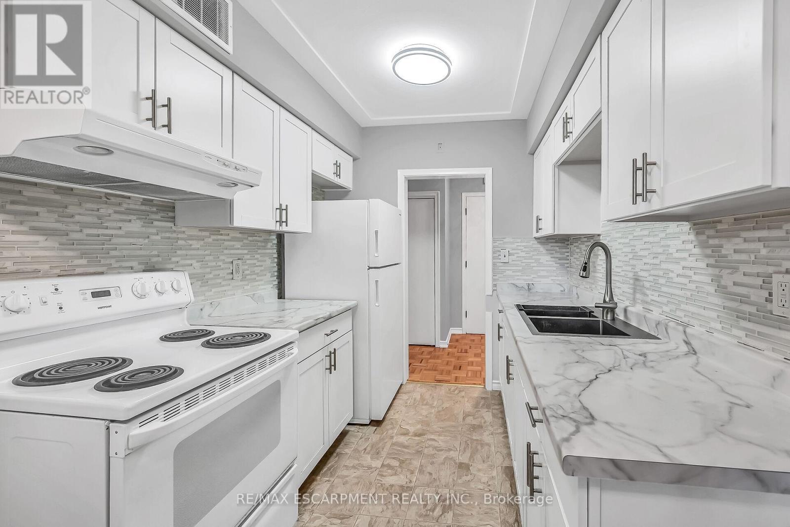 103 - 11 Woodman Drive S, Hamilton, ON - Indoor Photo Showing Kitchen With Double Sink