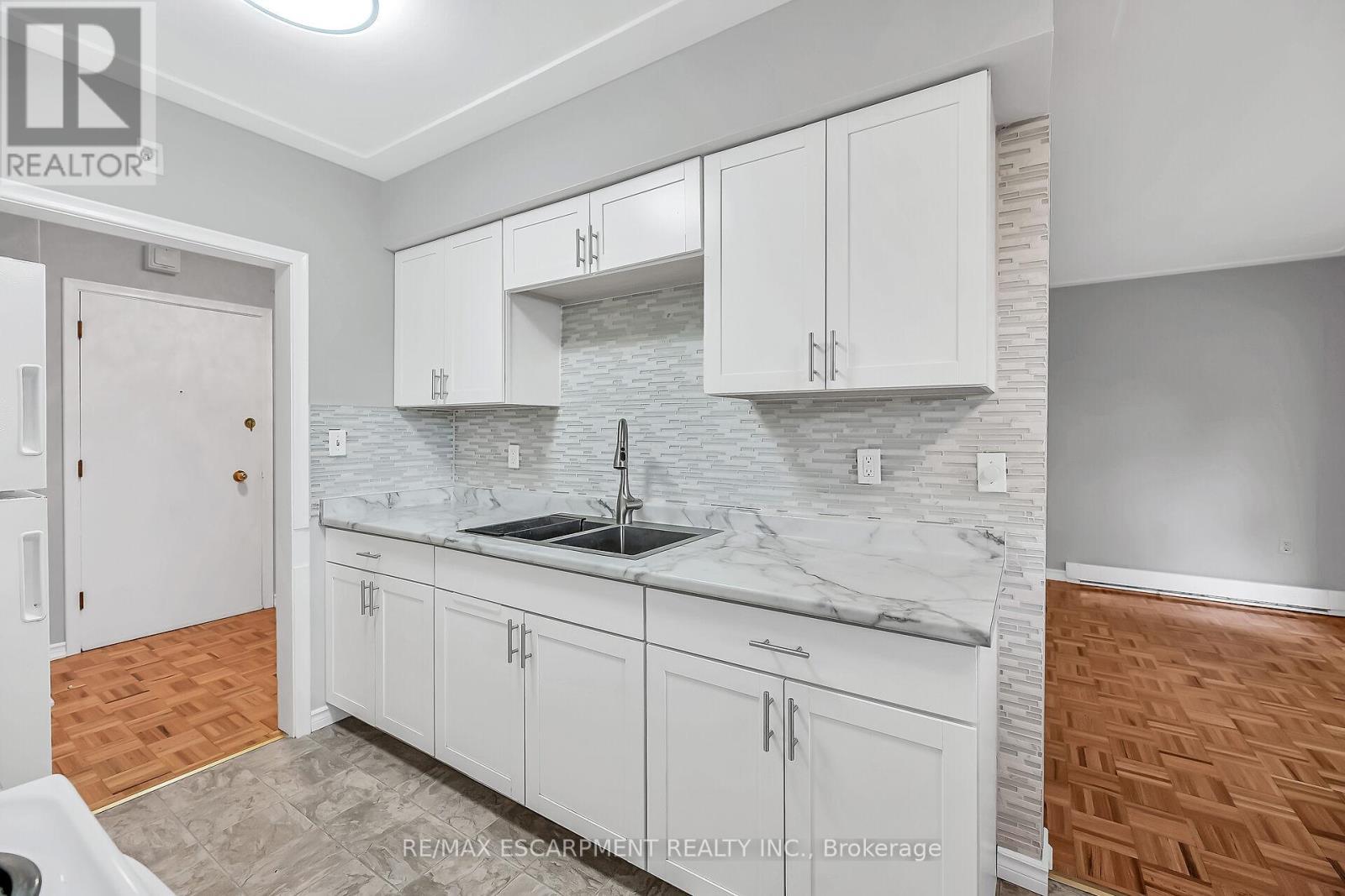 103 - 11 Woodman Drive S, Hamilton, ON - Indoor Photo Showing Kitchen With Double Sink