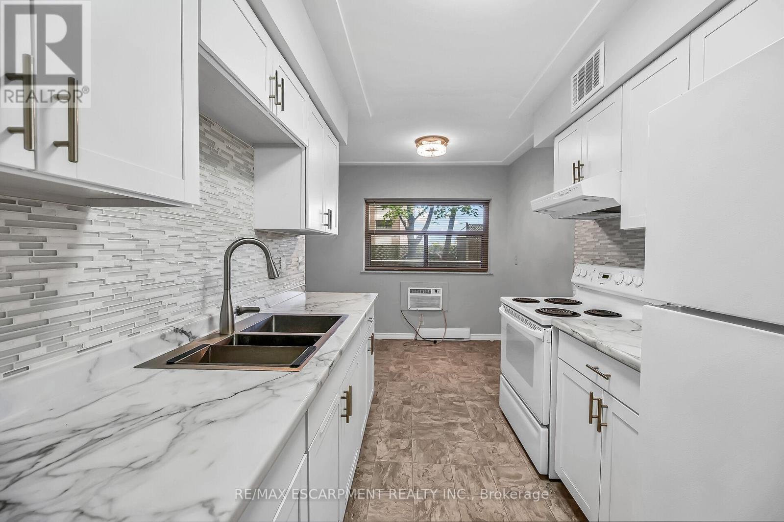 103 - 11 Woodman Drive S, Hamilton, ON - Indoor Photo Showing Kitchen With Double Sink