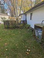 View of grassy yard featuring a deck -