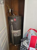 Utility room featuring electric water heater -