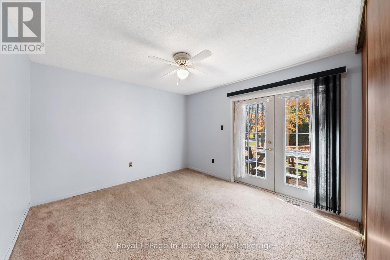 Primary Bedroom with W/O - 2 Coppercliff Crescent, Tiny, ON - Indoor Photo Showing Other Room