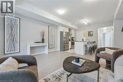 Living area with light wood finished floors and baseboards -