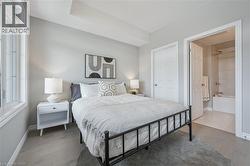 Bedroom with wood finished floors and ensuite bathroom -