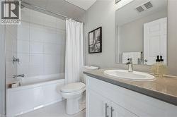 Bathroom with vanity, light tile patterned flooring, and shower / tub combo with curtain -