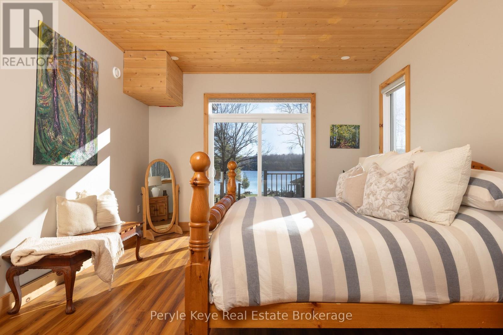 Walkout to Deck & Lake Views - 3191 Hwy 518 Highway E, Kearney, ON - Indoor Photo Showing Bedroom