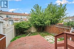 Large deck overlooks fully fenced backyard. -