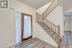 Foyer featuring wood finished floors and stairs -